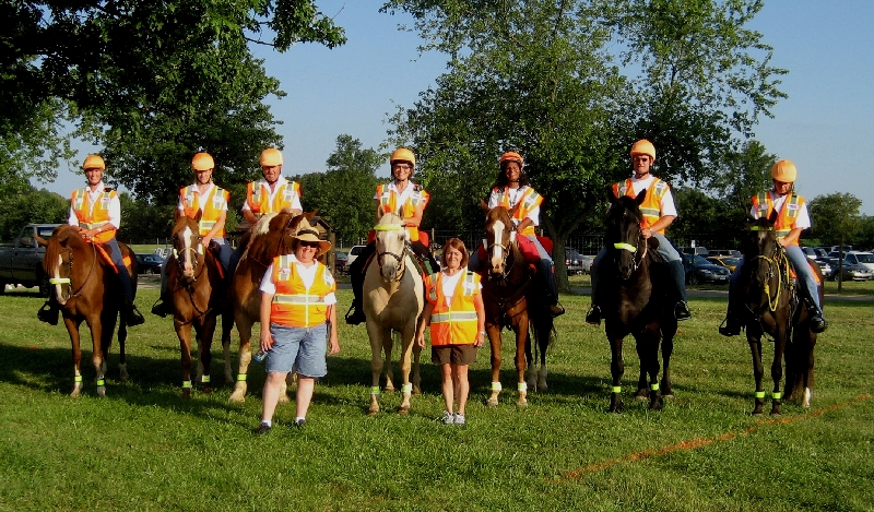 Illustrative photograph of an equestrian group wearing high-visibility vests